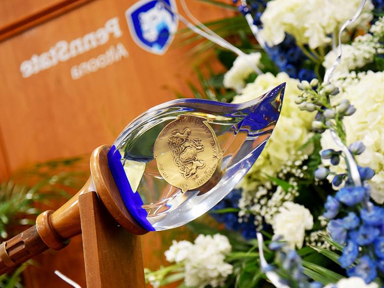 A close-up of the Academic Mace at a commencement ceremony